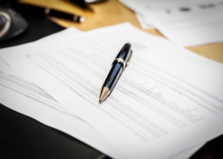 Pen laying on a report on a desk