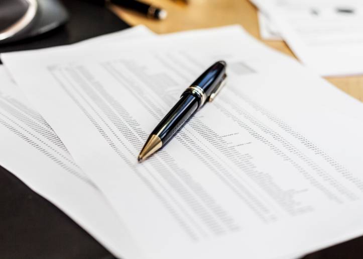 Pen laying on top of a report on a desk