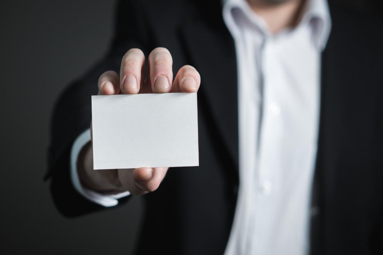 Man holding a blank business card