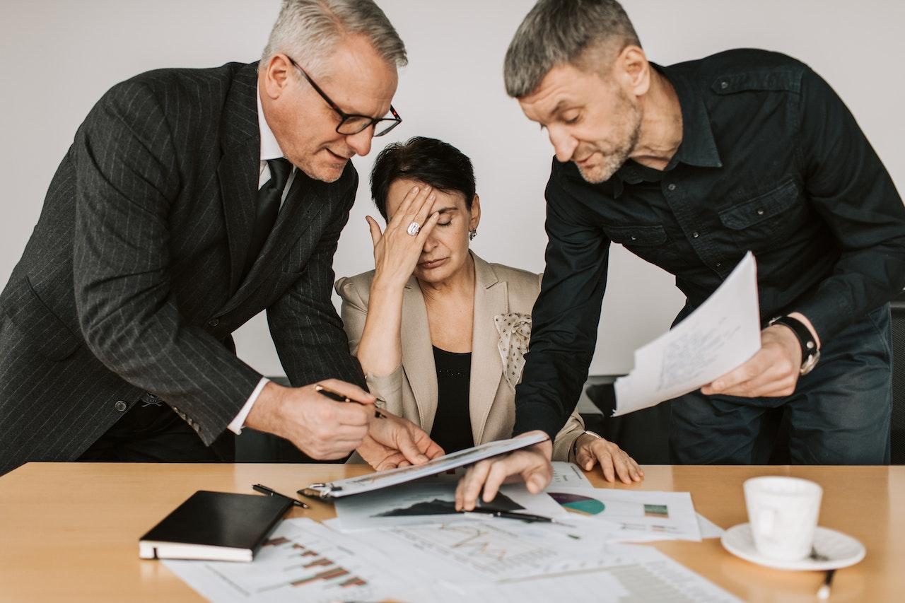 woman stressed between two colleagues